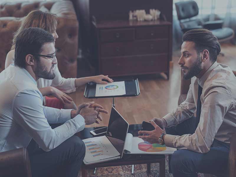 two men meeting with laptops