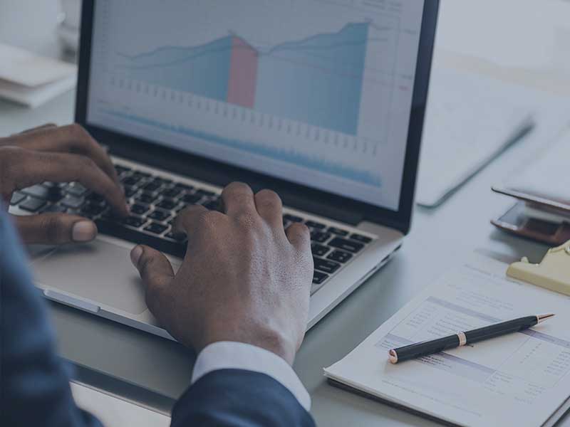 man typing on a laptop