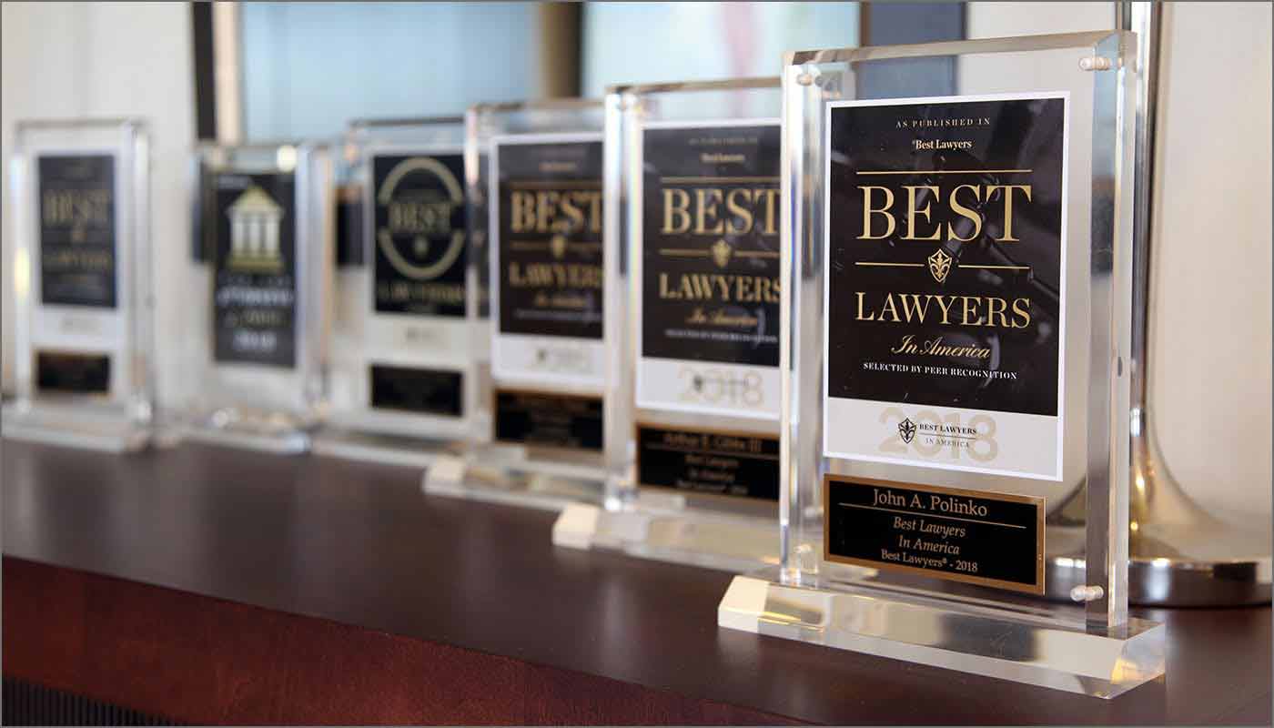 A desk of best lawyers trophies
