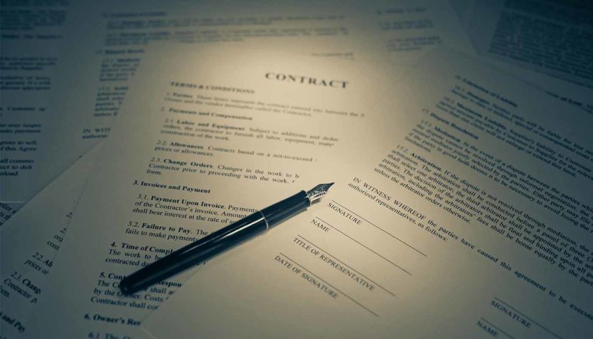 A pen resting on top of a contract